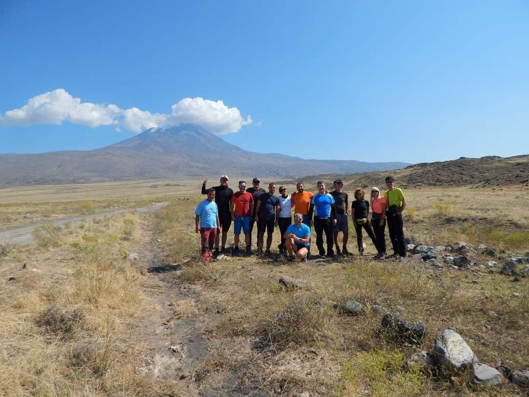 Climbers ascending Mount Ararat with a beautiful mountain landscape in the background